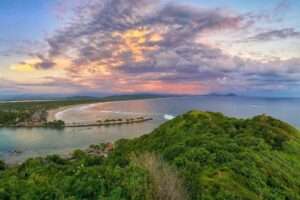 Bioluminescent lagoon and mangrove sanctuary at Lagunas de Chacahua with Afro-Mexican cultural elements.
