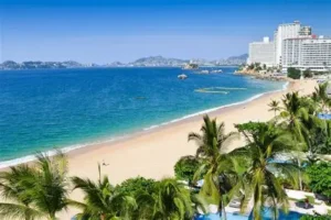 “Rocky shoreline and lighthouse at Punta Maldonado Beach, with Afro-Mexican fishing boats and coastal vegetation near the Oaxaca border.”