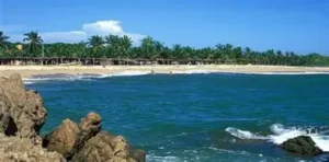 “Expansive shoreline at Marquelia Beach with warm Pacific waters, rustic palapas, and a tranquil Costa Chica backdrop.”